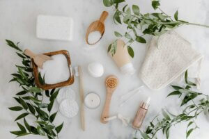 A collection of sustainable beauty products arranged on a marble surface, featuring eco-friendly skincare and bath essentials in line with clean beauty trends.