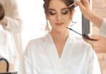 Close-up of a makeup artist in Palm Beach Gardens at work, using a brush and palette to create a stunning look on a woman preparing for a special event.