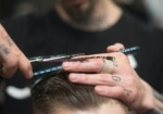 Close-up of a professional men's haircut in West Palm Beach, with a barber carefully shaping the client’s beard.