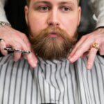 Professional beard groomer demonstrates the best practices for maintaining a clean-looking beard
