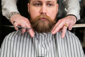 Professional beard groomer demonstrates the best practices for maintaining a clean-looking beard