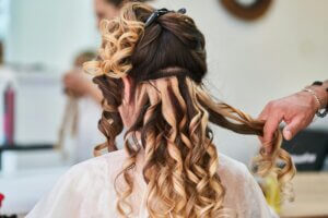 Professional hair extension installation showing the minimum hair length for extensions needed to hide the attachment tracks.